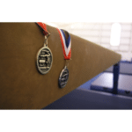 gymnastics medals on a beam